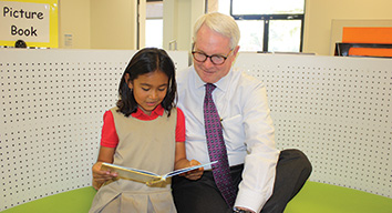 Robin Wantland reading with a little girl
